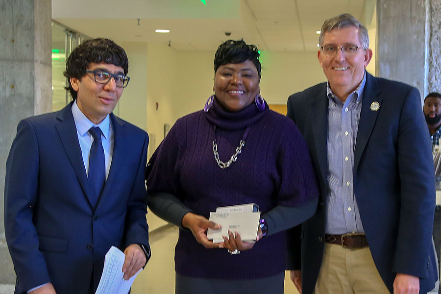 Shauna Bennett-Boyd, center, receives her award from awards committee chair Arash Yavari, left, and School Chair Donald Webster.  (Photo: Amelia Neumeister)