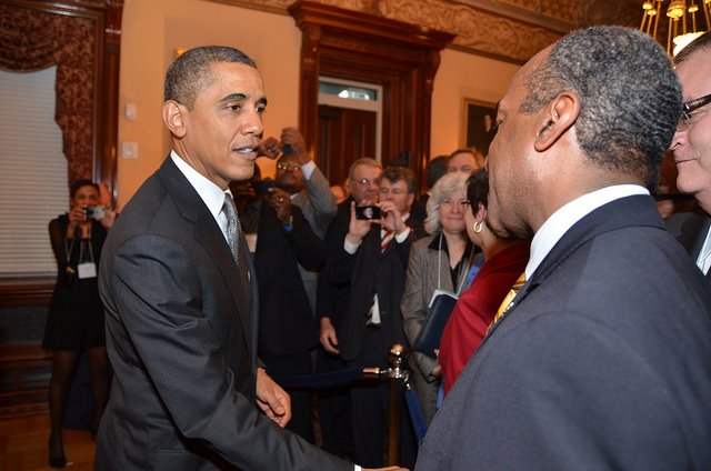 President Obama shaking hands with Dean Gary S. May at the White House.