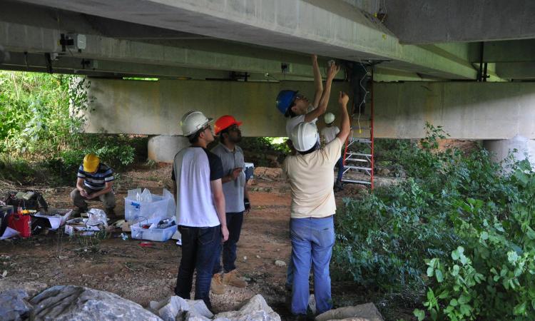 People under a bridge