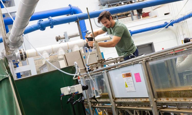 Man conducts experiment using a water tank