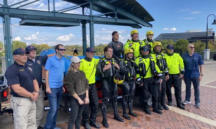 A group of divers and researchers pose in front of a boat in Columbus, Georgia.