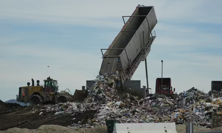 Trash being dumped into a landfill 