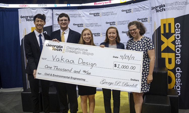 Vakaa Design — a team comprising, left to right, Justin Liu, Chris Folsom, Kailee Unangst and Hannah Davis — accepts the first-place check for civil and environmental engineering at the spring 2019 Capstone Design Expo alongside Associate Professor Kari Watkins. The team had to design the alignment of new express lanes along Interstate 285 in northwest Atlanta, including the structural elements to supported the elevated lanes. (Photo: Amelia Neumeister)
