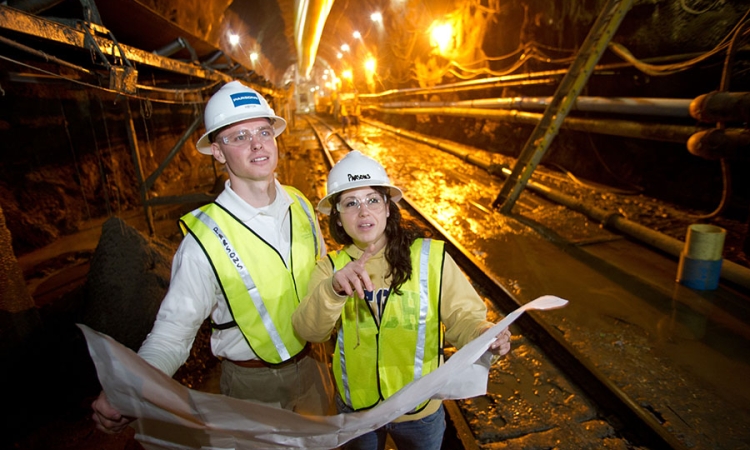 Students examine construction plans in a tunnel. (Photo: Rob Felt)