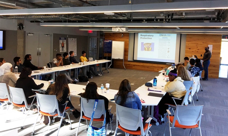 Students from the School of Civil and Environmental Engineering learn OSHA guidelines for worksite safety in early November. The Atlanta office of JE Dunn provided the training — and lunch — to the group of nearly two dozen undergraduate and graduate students. (Photo: Yong Cho)