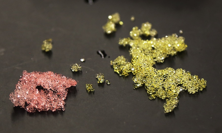 Two samples of the super-absorbent polymer beads Xing Xie is developing to improve diagnostic tests on biological samples in far-flung places. These beads, roughly half a millimeter in size, have been dyed so they're easier to see. (Photo: Jess Hunt-Ralston)