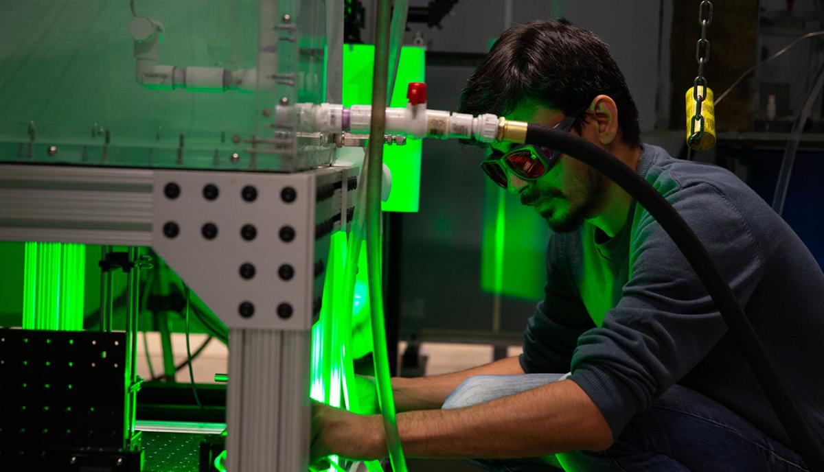 A man in protective goggles in a lab