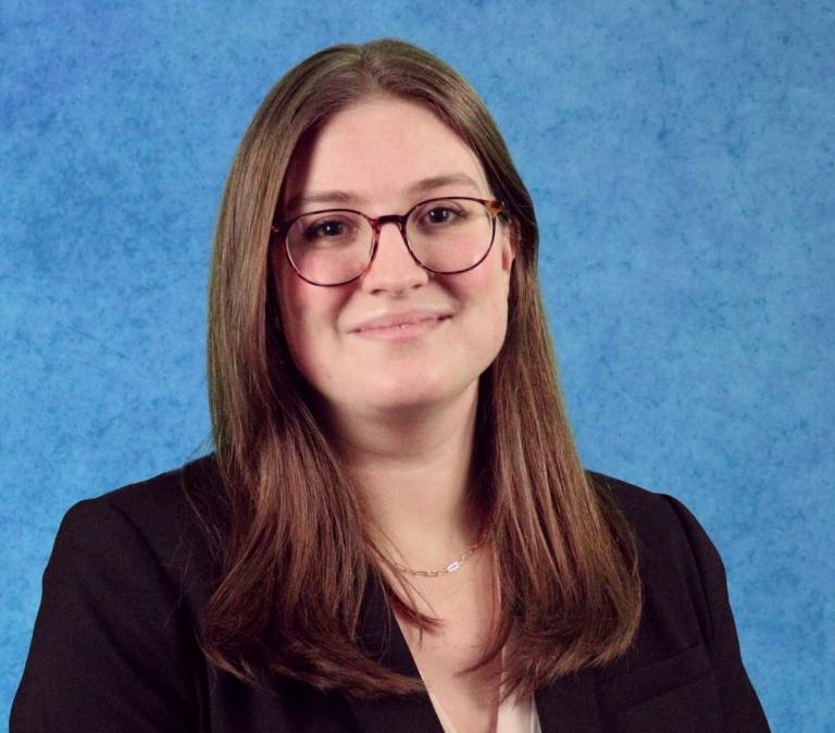 Portrait of Hannah Kessler wearing black jacket and beige blouse