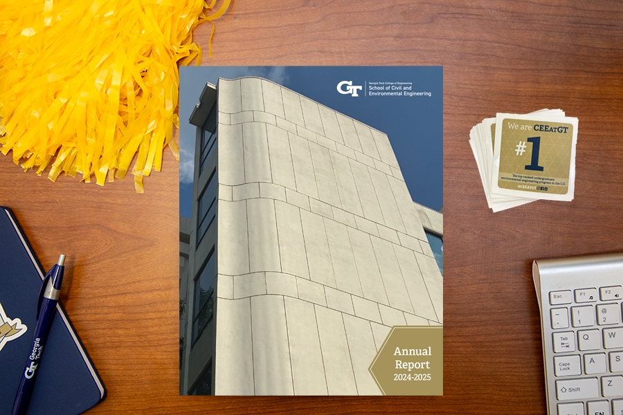 CEE Annual Report for 2024-2025 on a desk with a yellow cheerleader's pompom and a computer keyboard and #1 stickers