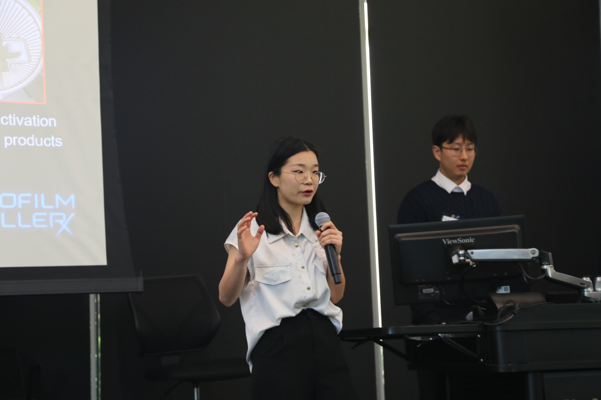 A woman and man from the team Biofilm Killer discuss their product at the 2025 EIC