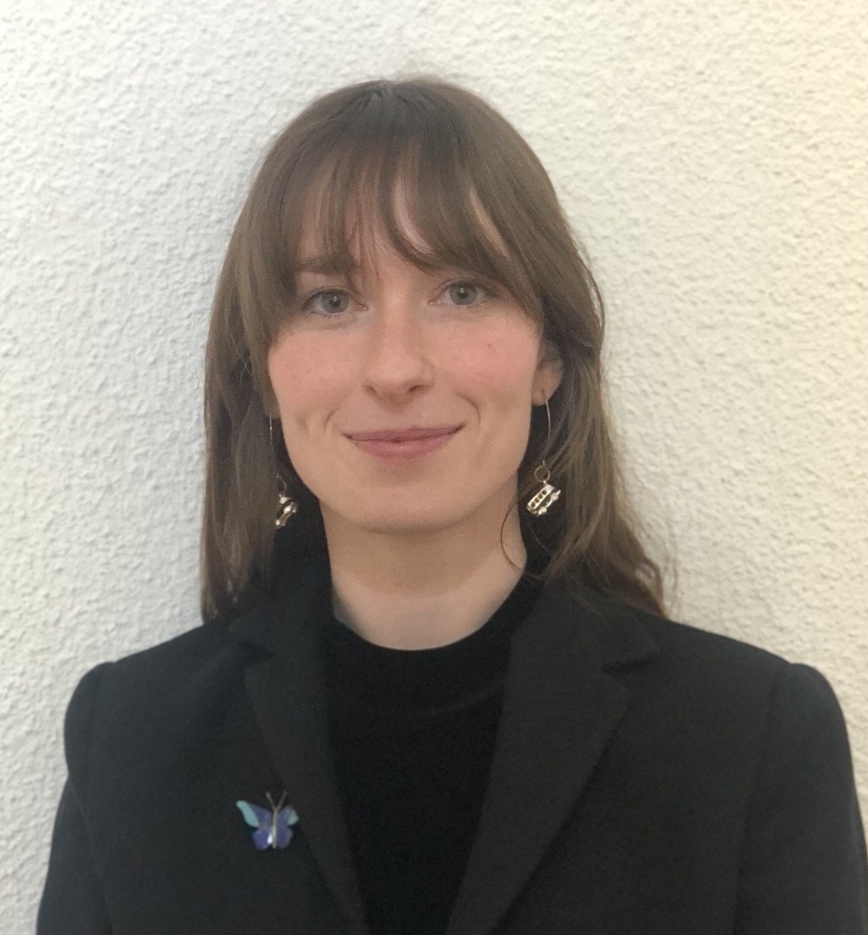 Portrait of Adair Garrett in a dark blazer with a black blouse