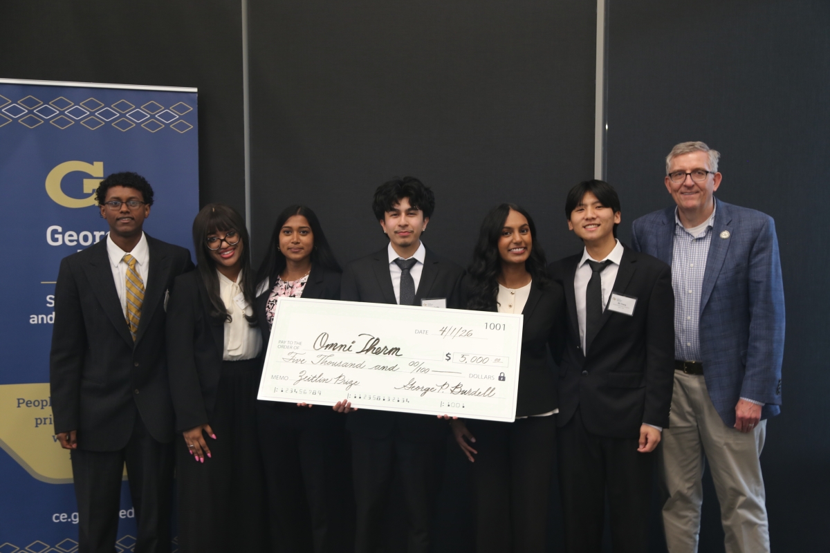 OmniTherm, a team of 3 men and 3 women accepting a check from Chair Don Webster for winning the Zeitlin Award