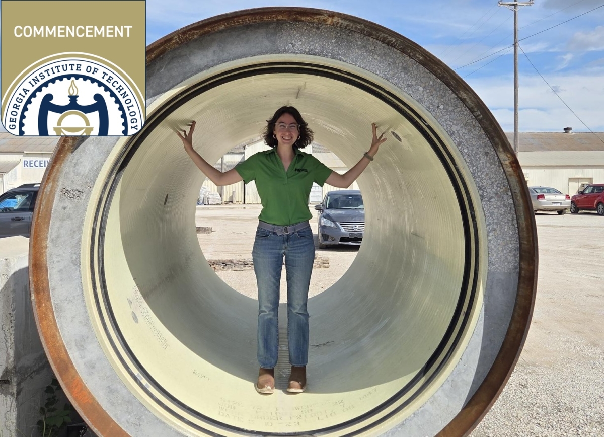 A woman stands in the center of a large section of pipe 