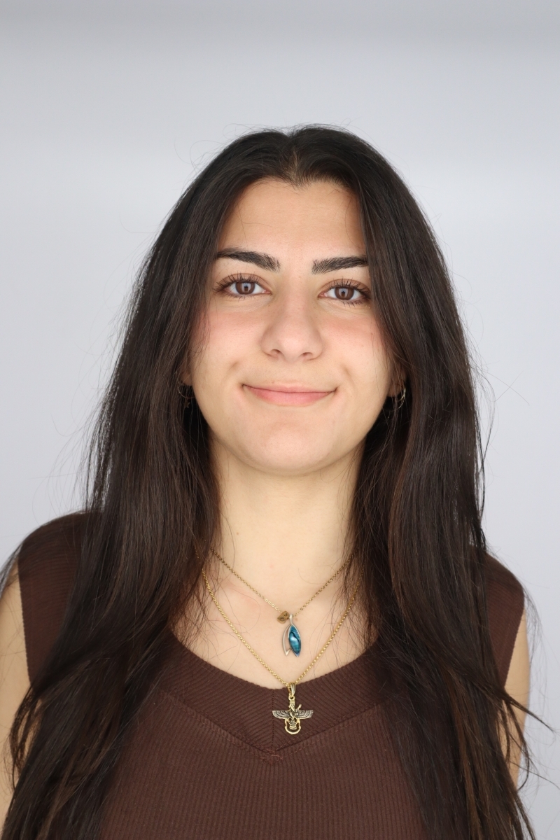 Portrait of Bahar Banihashemi in a brown top with two necklaces