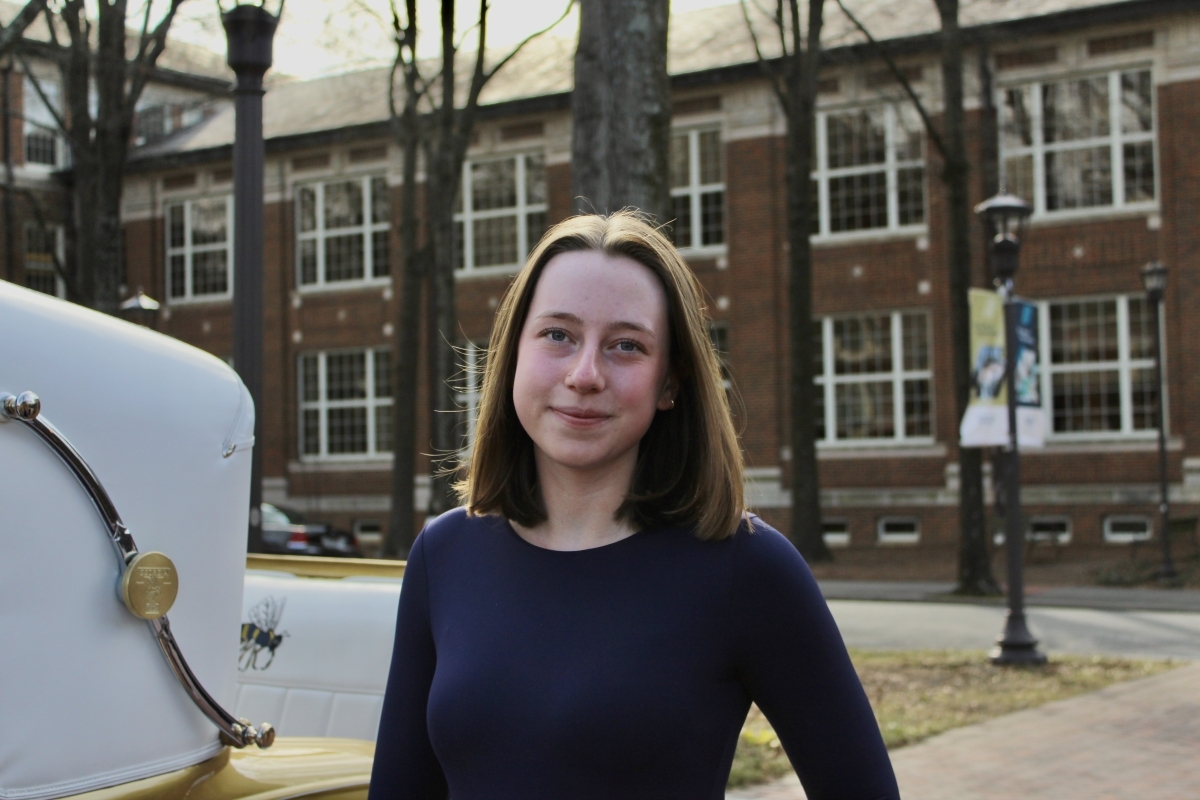 Portrait of Lucy Markovitz in a purple sweater in front of a Georgia Tech building