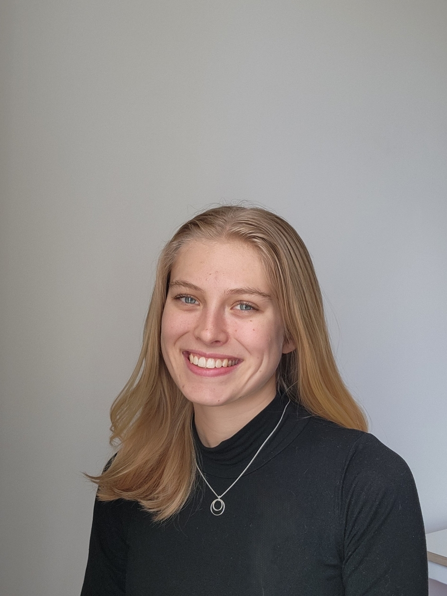 Portrait of Nina Roush in a dark grey blouse with a silver necklace