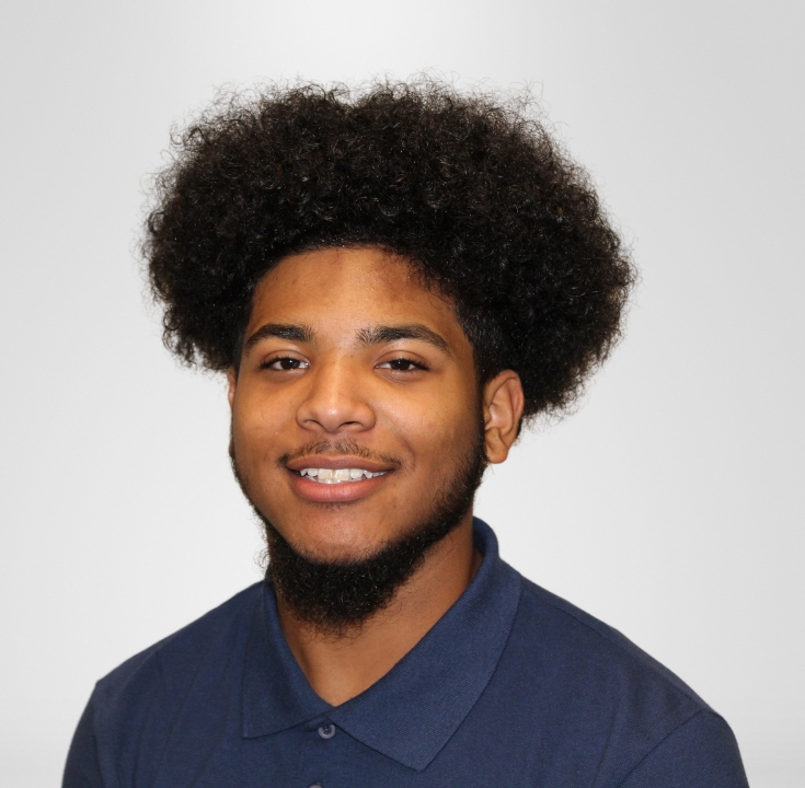 Portrait of Jonathan Rankine wearing a blue polo shirt