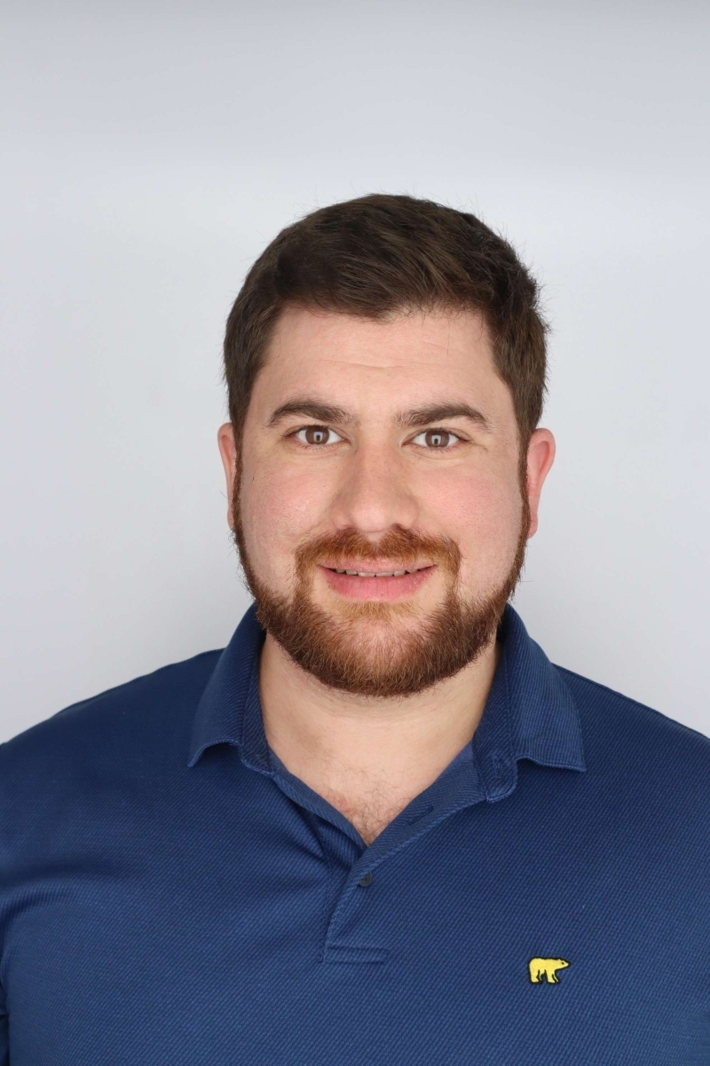 Portrait of Ryann Khalil in a blue polo with a golden bear insignia