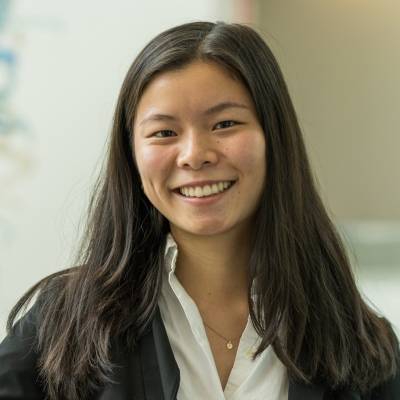 Portrait of Amanda Chin wearing a black blazer and a white blouse